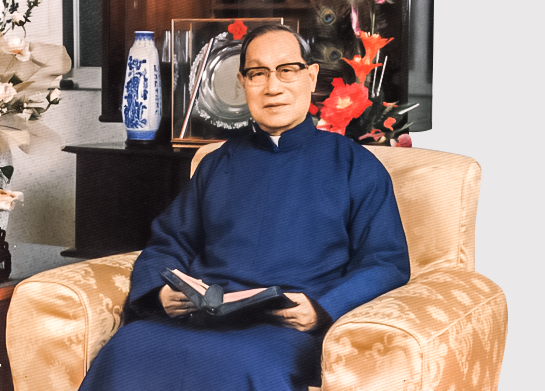 Father Yao, the founder of Fu Jen Sacred Heart, seated with an open book